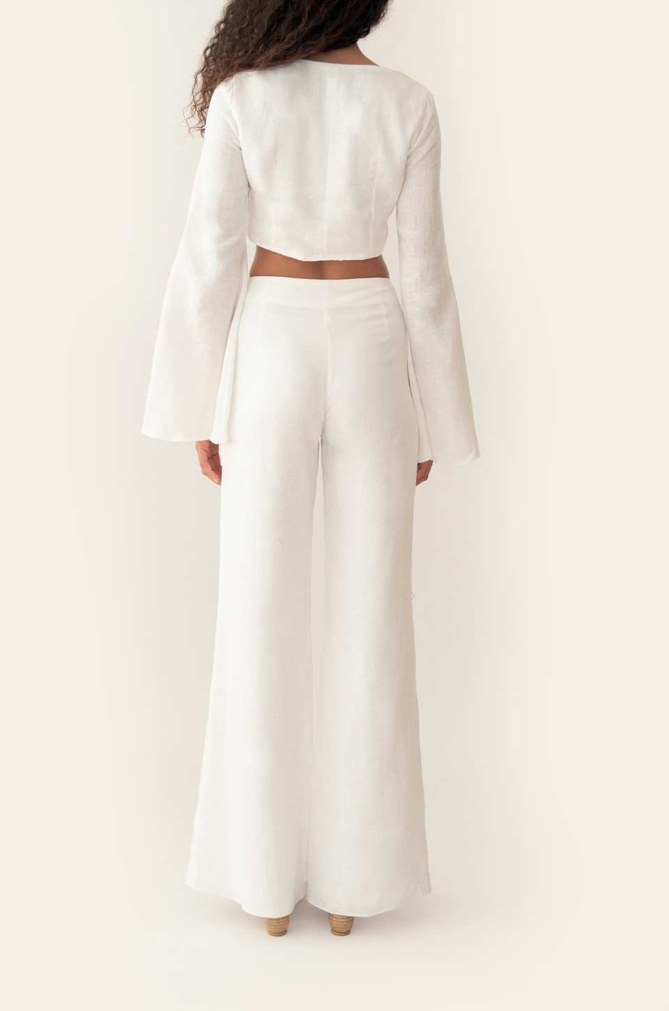 Azulu Amelie Pants back view, loose white linen wide-leg trousers falling uninterrupted to the floor