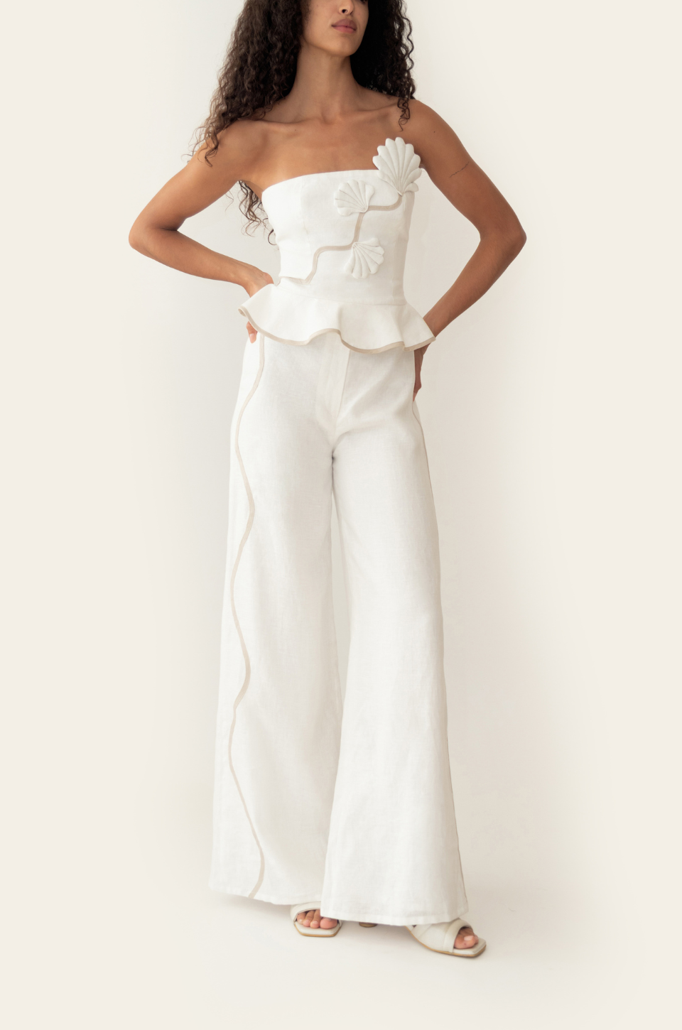 Azulu Vaiana Pants and Vaiana Top in white linen, three-quarter view showing the tonal trim curving down the front of each wide leg